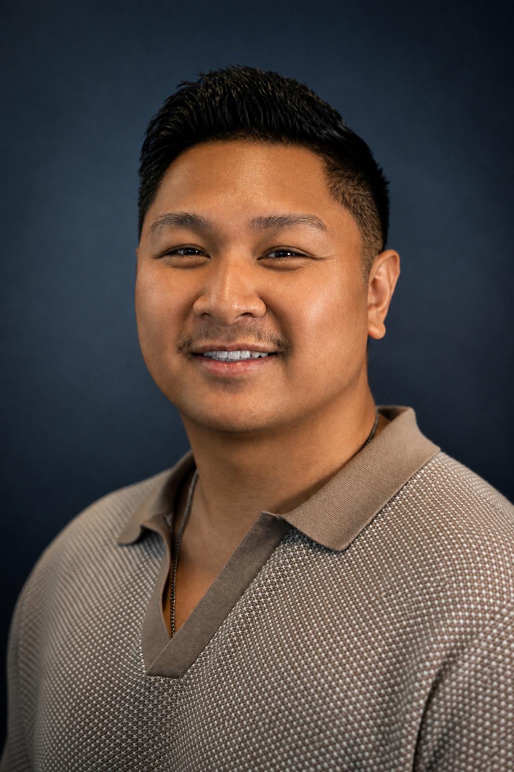 Calvin Van wearing a tan polo shirt
